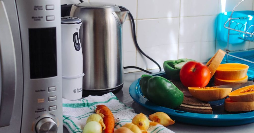 A modern home kitchen counter displaying fresh vegetables and appliances, ideal for healthy cooking.